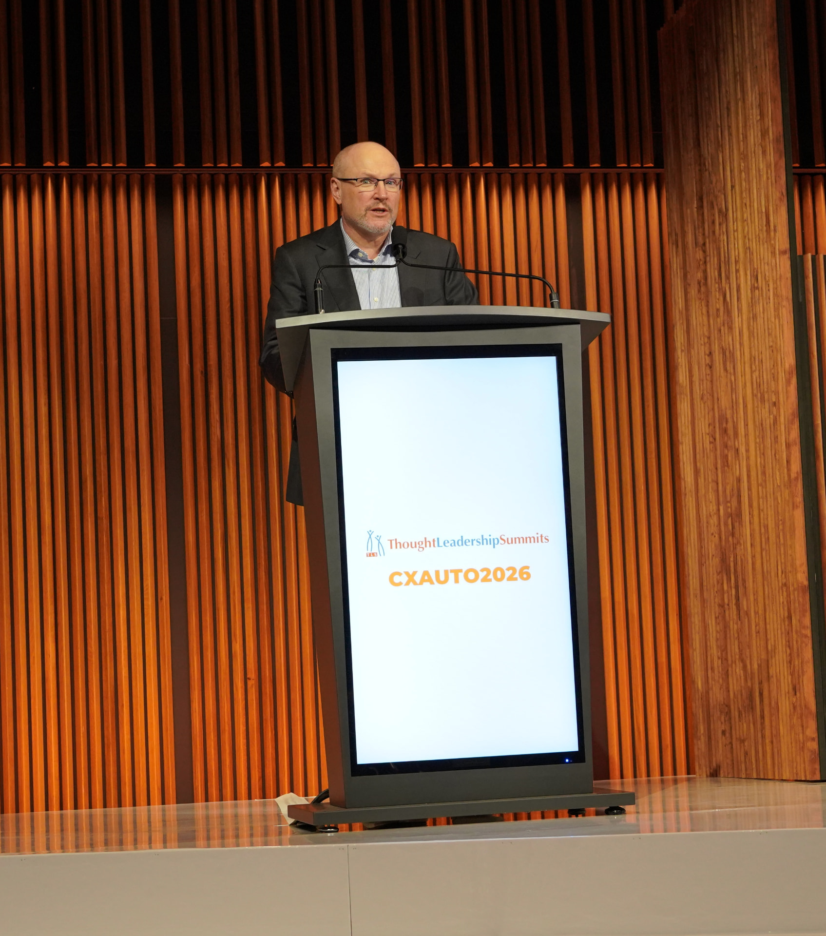 Ian Nethercott speaking from the podium at CXAUTO2026